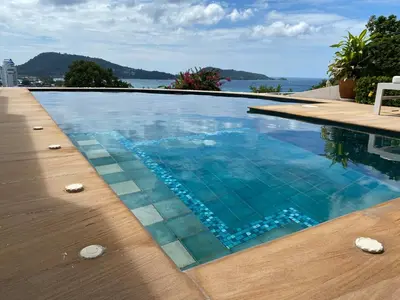 a swimming pool with a view of the water at Andaman hill pool Seaview three bedroom in Patong Beach