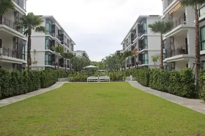 a park in front of some apartment buildings at Beach Front Condo on Rawai Beach in Rawai Beach