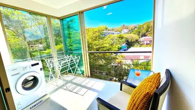 a room with a washing machine and a window at Phuket KAMALA Apartment in Phuket Town