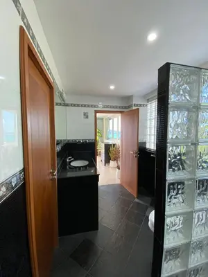 a bathroom with a sink and a glass wall at Andaman Hills pool Seaview house in Patong Beach