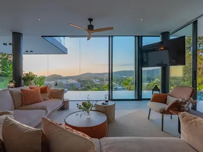 a living room with couches and a flat screen tv at NEW Luxury Seaview 3BR Villa in Layan - Villa Luma in Layan Beach