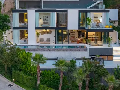 an aerial view of a house with a swimming pool and palm trees at NEW Luxury Seaview 3BR Villa in Layan - Villa Luma in Layan Beach