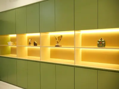 a room with green cabinets and shelves with vases on them at Bernard Travel in Phuket Town