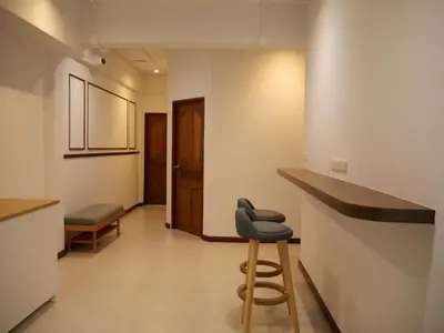 a bar in a room with a stool and a counter at Bernard Travel in Phuket Town