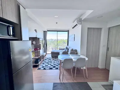a kitchen and living room with a table and chairs at Laguna Skypark 2 Bedroom scenic view in Laguna Phuket