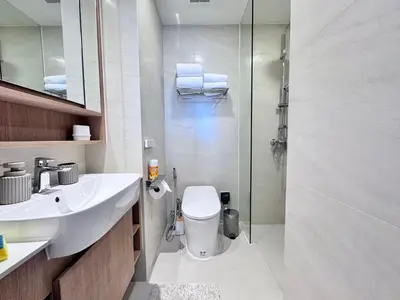 a bathroom with a toilet and a sink and a shower at Skypark New Building 4th floor Mountain View in Laguna Phuket