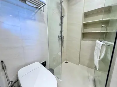a bathroom with a toilet and a glass shower at Skypark New Building 4th floor Mountain View in Laguna Phuket