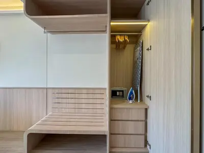 a room with a walk in closet with a bench at Great Apartment Sea Heaven 2 min to Nai Thon Beach in Nai Thon Beach
