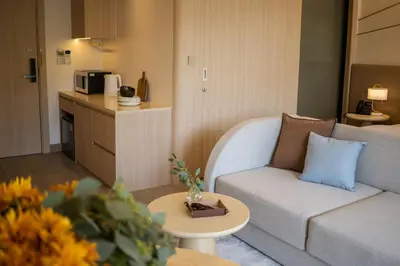 a living room with a couch and a table at Great Apartment Sea Heaven 2 min to Nai Thon Beach in Nai Thon Beach