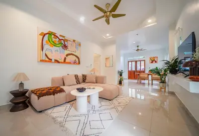 a living room with a couch and a table at Greenleaf Estate - Gated Villas with large shared pool, Nai harn beach in Rawai Beach