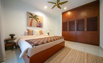 a bedroom with a bed and a ceiling fan at Greenleaf Estate - Gated Villas with large shared pool, Nai harn beach in Rawai Beach
