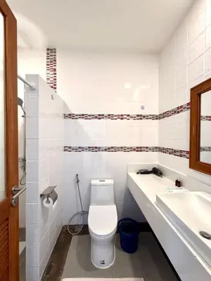 a white bathroom with a toilet and a sink at Cozy Thai-Style House with Private Pool, Bang Tao in Ban Pak Lak