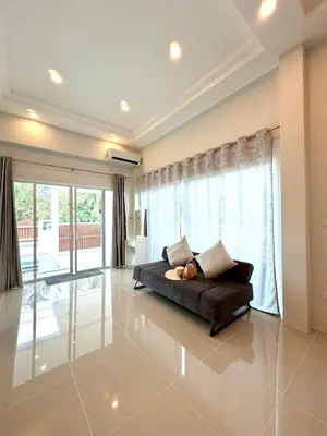 a living room with a couch and a large window at Cozy Thai-Style House with Private Pool, Bang Tao in Ban Pak Lak