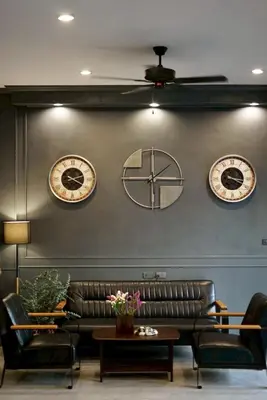 a living room with three clocks on the wall at The Sense 2 in Patong Beach