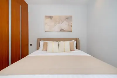 a bed with white sheets and pillows in a bedroom at NEW Luxury 4BR Villa with Pool & relaxation zones D07 in Phuket