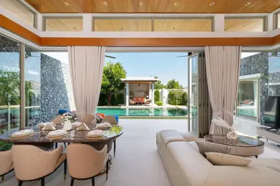 an open living room with a table and chairs at NEW Luxury 4BR Villa with Pool & relaxation zones D07 in Phuket