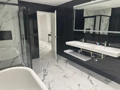 a bathroom with two sinks and a shower at Elite Luxury Apartment Patong in Patong Beach