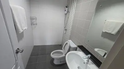 a white bathroom with a toilet and a sink at Phuket villa airport in Nai Yang Beach