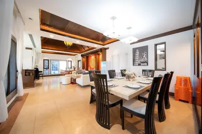 a dining room and living room with a table and chairs at D Villa Phuket-Luxury 6-Bedroom Private Villa in Panwa Entire Place in Phuket Town