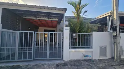a house with a gate in front of it at Joyful House Naiyang beach in Thalang