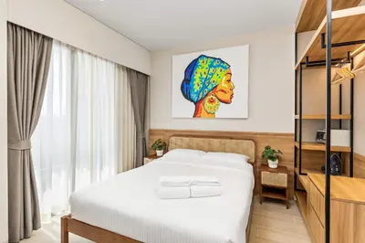 a hotel room with a bed and a television at Laguna LakeSide Residences by My Home Phuket in Bang Tao Beach