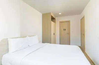 a white bedroom with a large white bed at C262 Relax 2BR Condo with Pool and Full Gym in Kathu