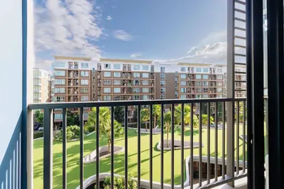 a balcony with a view of a large building at C262 Relax 2BR Condo with Pool and Full Gym in Kathu