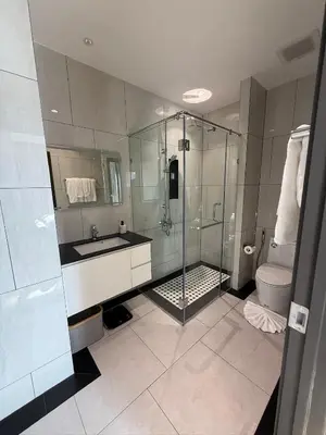 a bathroom with a shower and a sink and a toilet at Legendary F705 - Top floor family 1BR - The Title Legendary by UNO in Bang Tao Beach