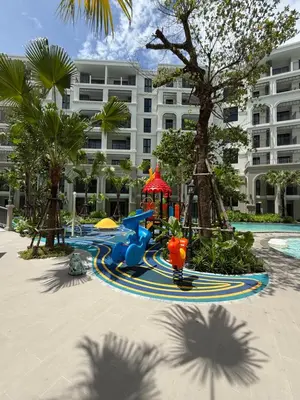 a playground in front of a large building at Legendary F705 - Top floor family 1BR - The Title Legendary by UNO in Bang Tao Beach