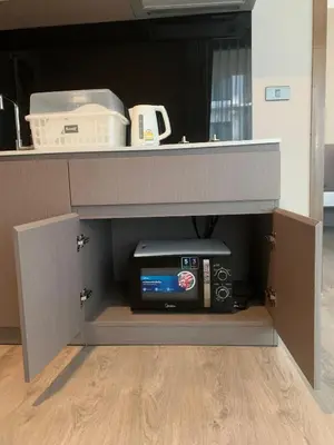a cabinet with a desk with a computer and a printer at Royal Lee The Terminal Phuket in Thalang