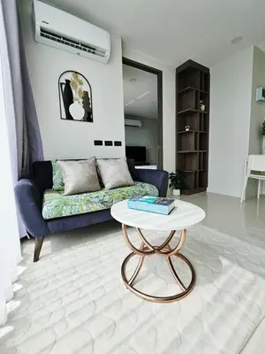 a living room with a couch and a coffee table at patong see view condo in Patong Beach