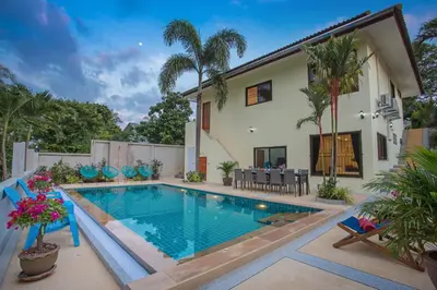 a swimming pool in front of a house at Large Private Pool 5BR Villa Tony near Promthep Cape in Nai Harn Beach