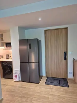 a kitchen with a stainless steel refrigerator and a door at 3 bedrooms in Laguna, Bangtao Beach 5 min walk in Bang Tao Beach