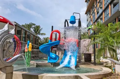 a playground with a water slide in a fountain at Ocean Breeze 1-BR apartment, Sea View, Surin beach in Ban Lum Fuang
