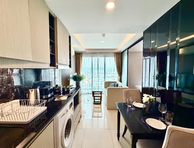 a kitchen with a dishwasher and a table in a room at Ocean Breeze 1-BR apartment, Sea View, Surin beach in Ban Lum Fuang