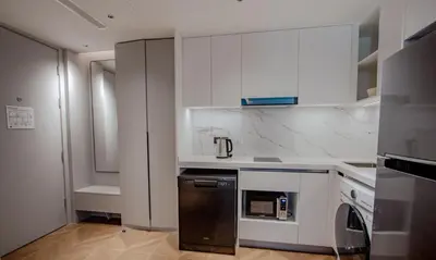 a kitchen with white cabinets and a dishwasher at Kora 77 2BR Beachfront Condo with Sea View and Pool in Phuket Town