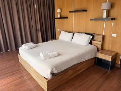a bedroom with a bed with two pillows on it at Villa DIAZ RAWAI in Ban Saiyuan (1)