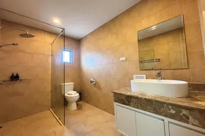 a bathroom with a sink and a toilet at Grand Villa Ishu 4BR Private Pool in Kamala Beach