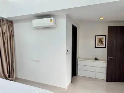 a bedroom with a bed and a air conditioner on the wall at Laguna villa with private pool in Ban Phru Champa