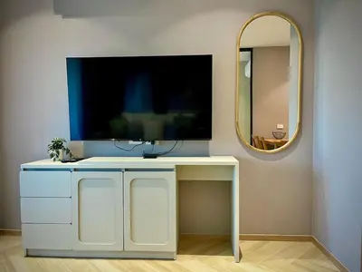 a white desk with a tv on a wall with a mirror at Title Legendary Apartment 1 Bdr Bang Tao in Bang Tao Beach