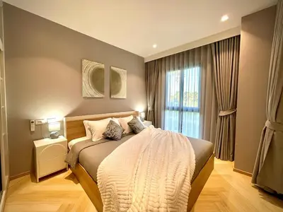 a bedroom with a large bed and a window at Title Legendary Apartment 1 Bdr Bang Tao in Bang Tao Beach