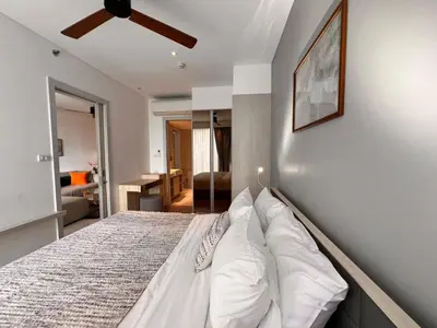 a bedroom with a bed with a ceiling fan at Cassia Residences Condo in Laguna Phuket in Laguna Phuket