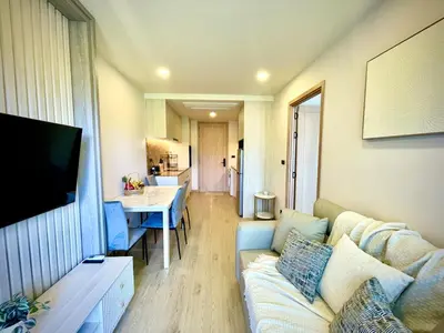 a living room with a couch and a table at The Ozone Residences Bangtao Beach 1Bdr in Laguna Phuket