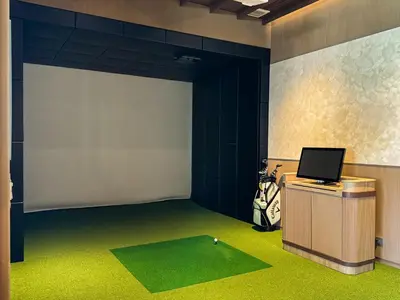a room with a screen with a golf ball on a table at Lovely 2 Bdr Canvas BangTao in Laguna Phuket