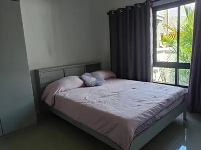 a bed with two stuffed animals on it in a bedroom at Jenny Naiyang Beach in Phuket