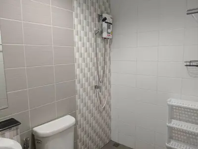 a bathroom with a shower with a toilet in it at Jenny Naiyang Beach in Phuket