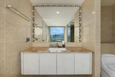 a bathroom with a sink and a toilet at Suite Anafi 2BR Pool Gym Access Ozone in Laguna Phuket