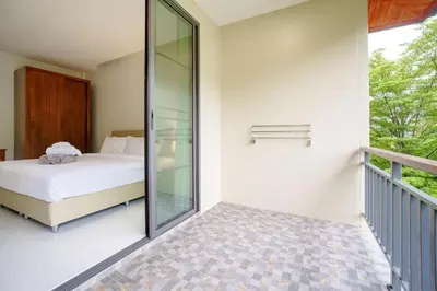 a bedroom with a bed and a balcony at 1 Bedroom Villa - 2 Minutes to Nai Harn Beach A103 in Rawai Beach