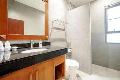 a bathroom with a sink and a toilet and a mirror at 1 Bedroom Villa - 2 Minutes to Nai Harn Beach A103 in Rawai Beach