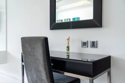 a black desk with a chair and a mirror at Sea view studio near Tri Trang & Merlin beach in Patong Beach